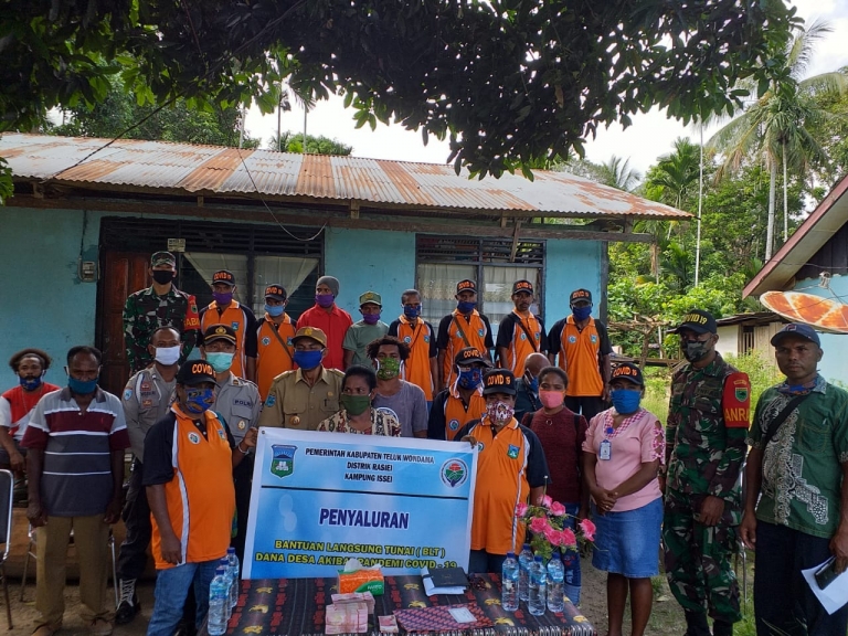 Ipda Nurkolis mengawal pembagian Bantuan Langsung Tunai (BLT) di kampung Isey, Distrik Rasiei, Kamis, 14 Mei 2020.
