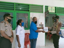  Kapolsek Warsa Iptu M. L. Sarlatta didampingi Bhabinkamtibmas Brigadir Sudirman SH, menyerahkan secara simbolis bantuan masker kepada Puskesmas Warsa, Selasa (26/5/2020). 